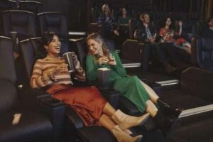 Palace Theatre exterior with a marquee advertising summer movie screenings.