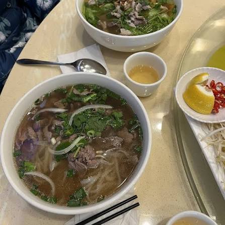 Bowls of beef pho with rice noodles and herbs at Pho M Viet Vietnamese restaurant Moonee Ponds